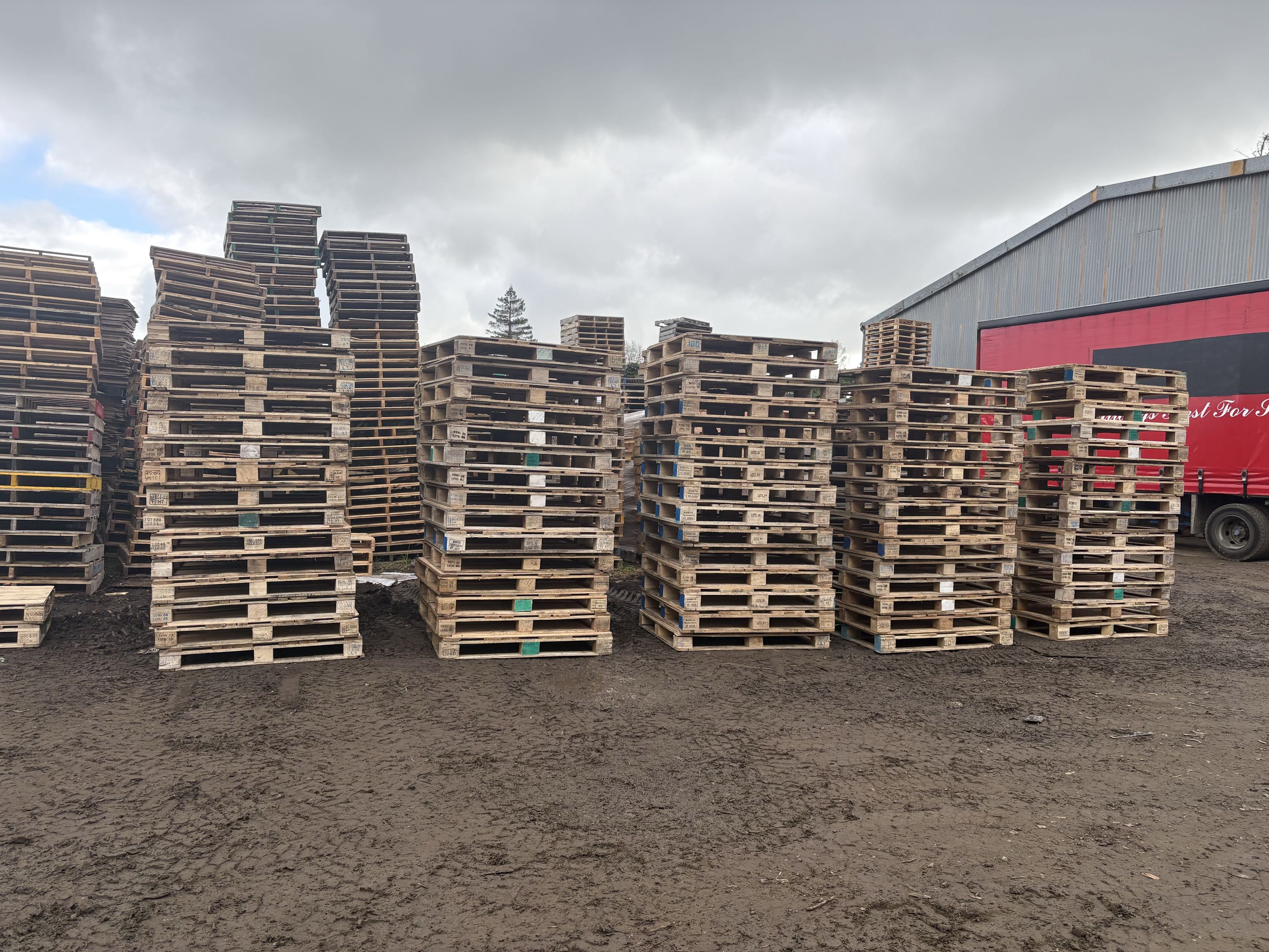 a photo of a stack of mixed grade wooden pallets