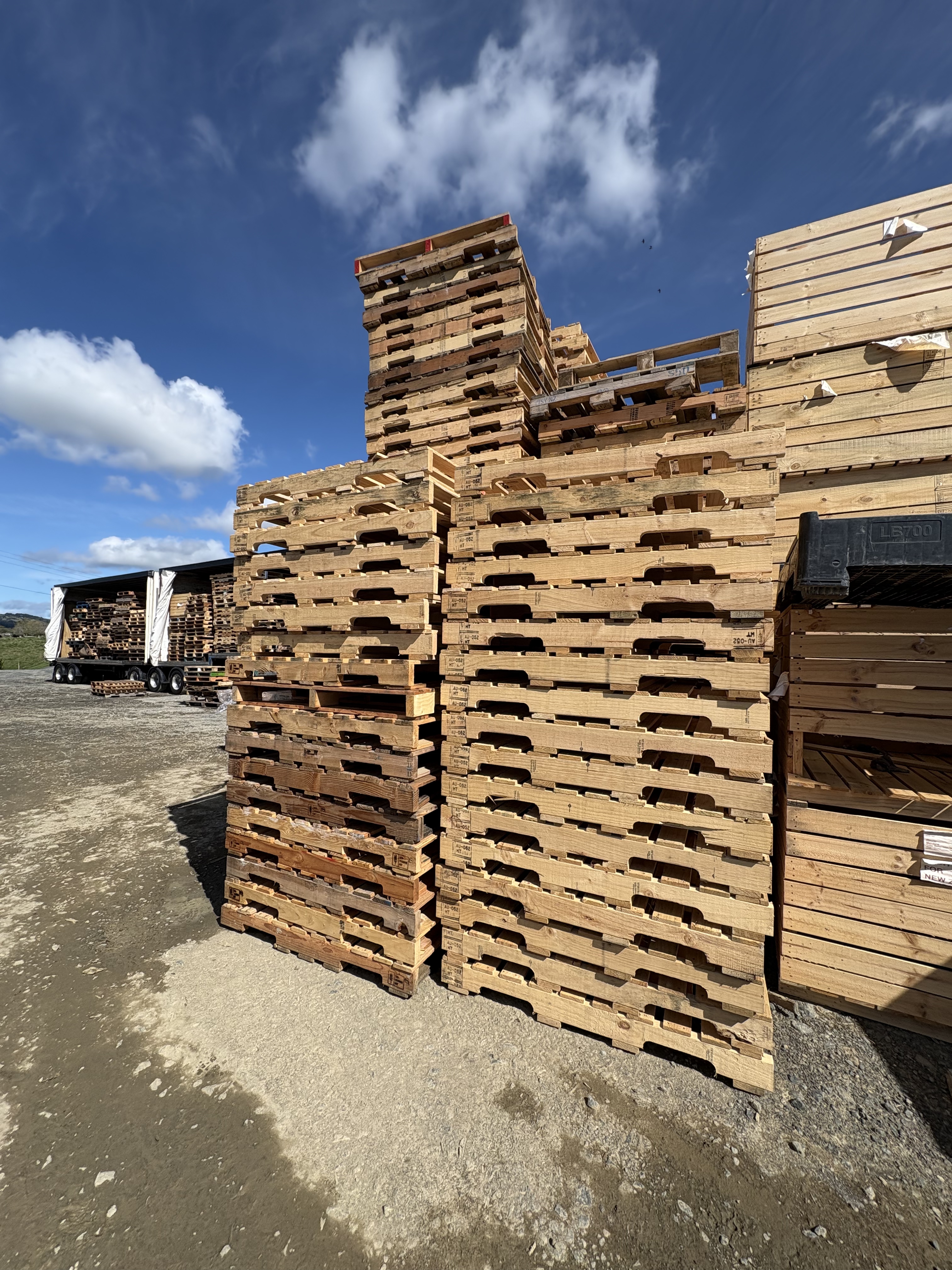 a photo of a stack of mixed grade wooden pallets